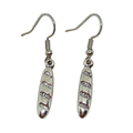 Pair of silver French baguette bread loaf earrings with textured design on a white background