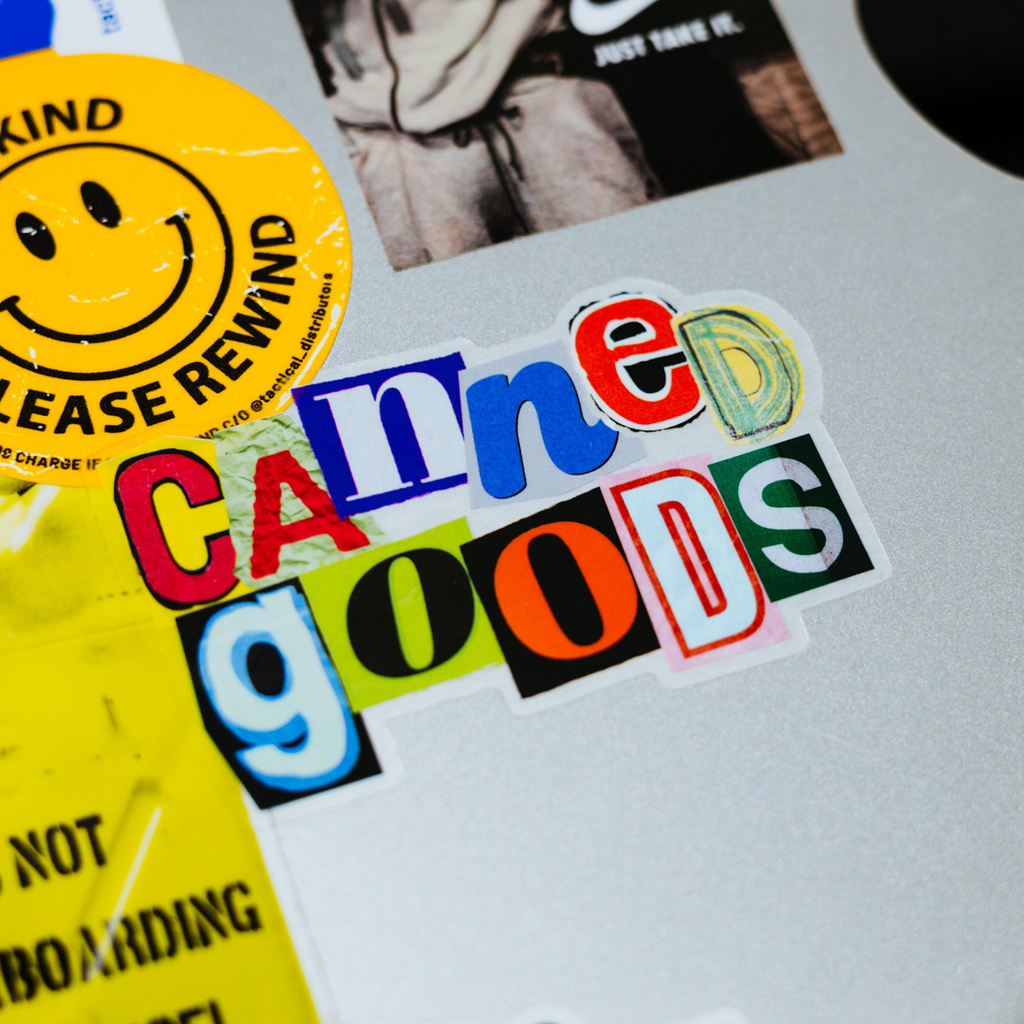 Colorful sticker with text and a smiley face on a textured surface