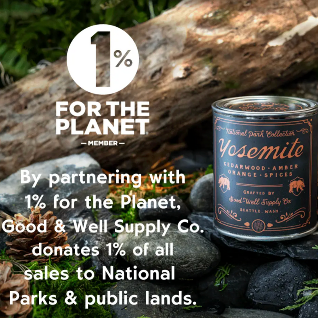 Candle with '1% for the Planet' label on a natural background