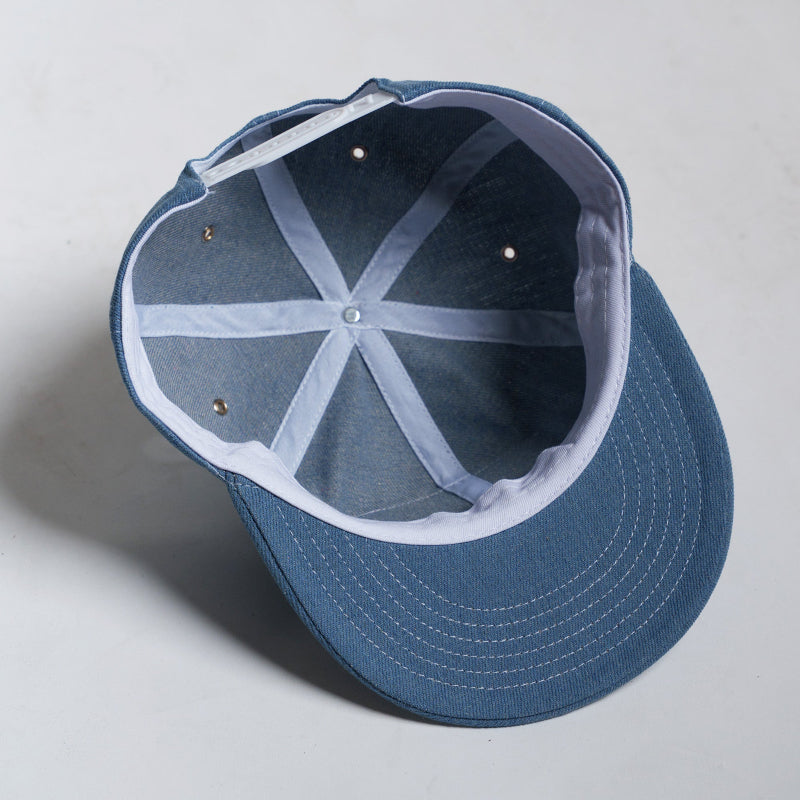 Blue cap with a white interior on a light gray background