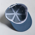 Blue cap with a white interior on a light gray background
