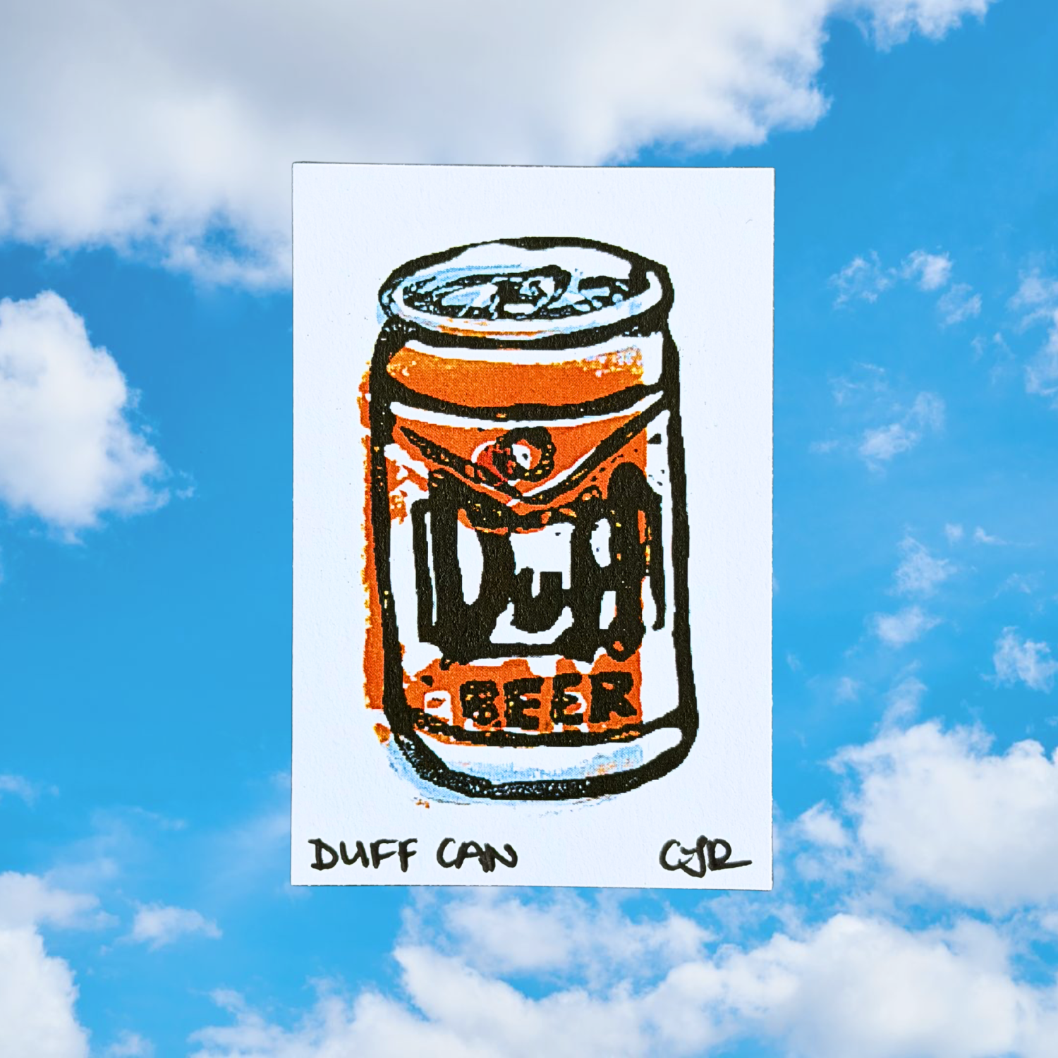 Linoleum carved print of a Duff Beer can with a blue sky and clouds in the background
