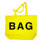 Yellow tote bag with 'BAG' printed on it against a white background