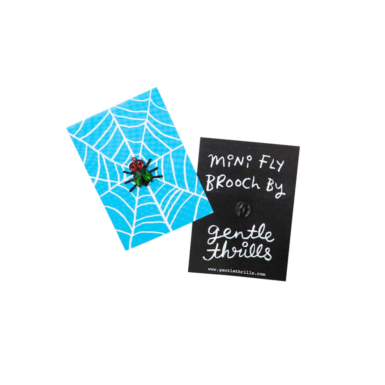 Fly-themed brooch with spider web design on a blue card, branded 'gentle thrills'.