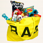 Yellow tote bag filled with snacks and toys on a white background