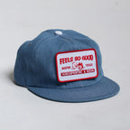Blue denim cap with a red and white patch on a light gray background