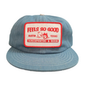 Blue denim trucker cap with a white and red mechanic patch on a white background