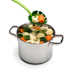 Monstera leaf slotted serving spoon lifting cooked vegetables from a stock pot, allowing water to drain while serving.
