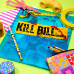 Colorful stationery items including a 'Kill Bill' bumper sticker on a blue folder.
