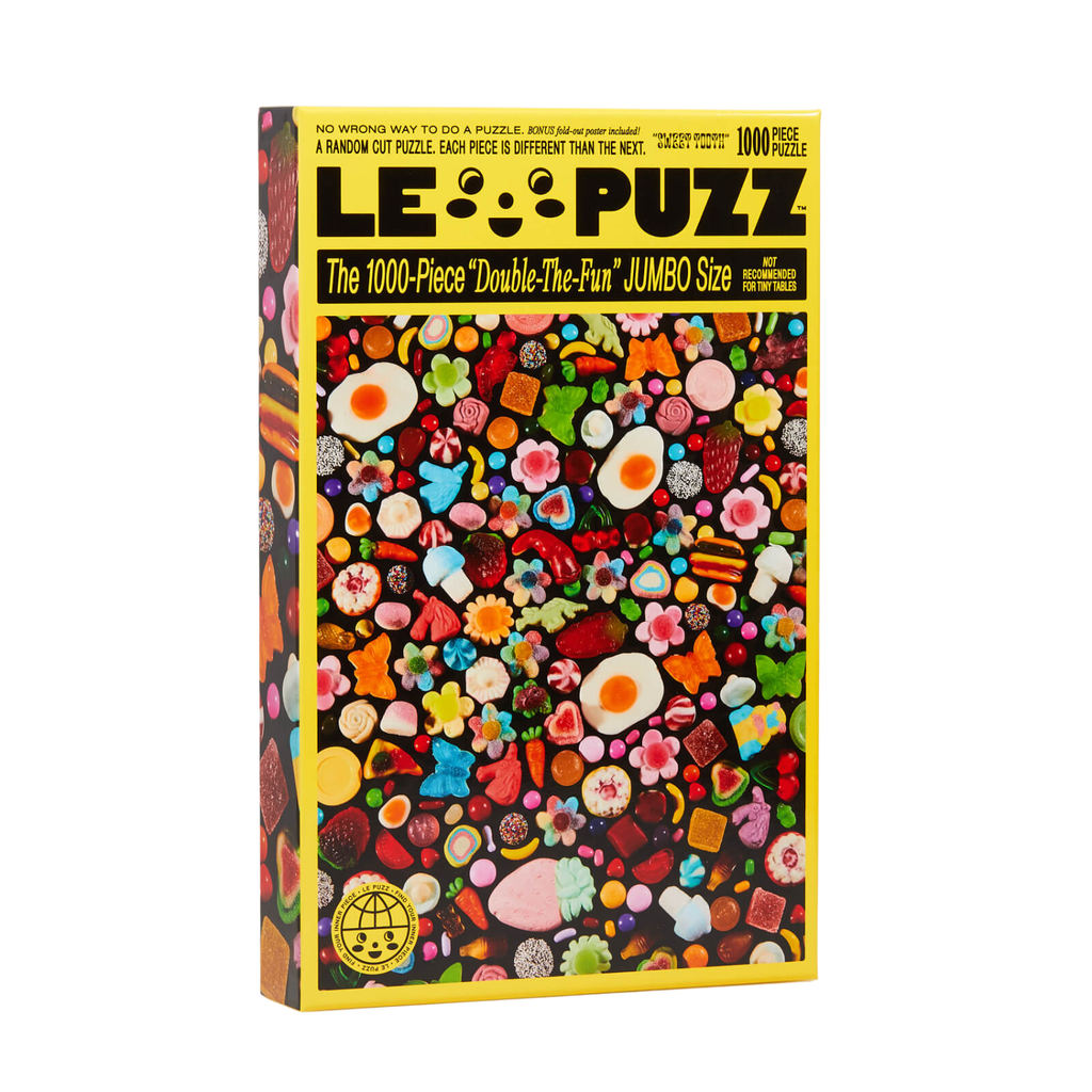A 1000-piece jigsaw puzzle box titled 'LE PUZZ' featuring a vibrant, multicolored candy-themed illustration on the front, set against a plain white background.