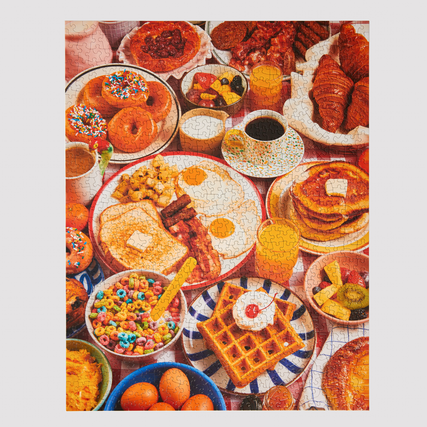 Jigsaw puzzle of colorful breakfast scene with various foods including waffles, donuts, and cereal.