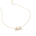 A delicate gold chain bracelet featuring a small, brushed textured gold crab pendant, displayed on a clean white background.