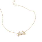 A delicate gold chain bracelet featuring a small, brushed textured gold crab pendant, displayed on a clean white background.