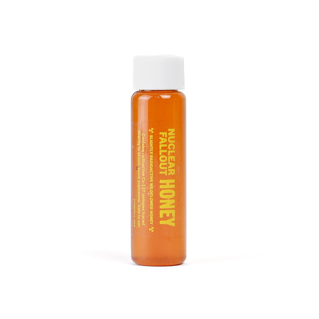 Small bottle of Nuclear Fallout Radioactive honey with a white cap on a white background