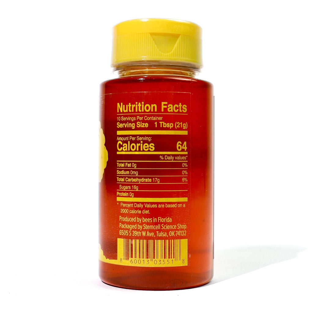 Bottle of honey with nutrition facts label on a white background