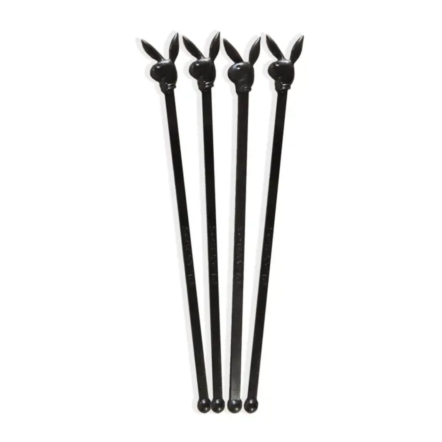 Set of four black Playboy Bunny-shaped stir sticks on a white background