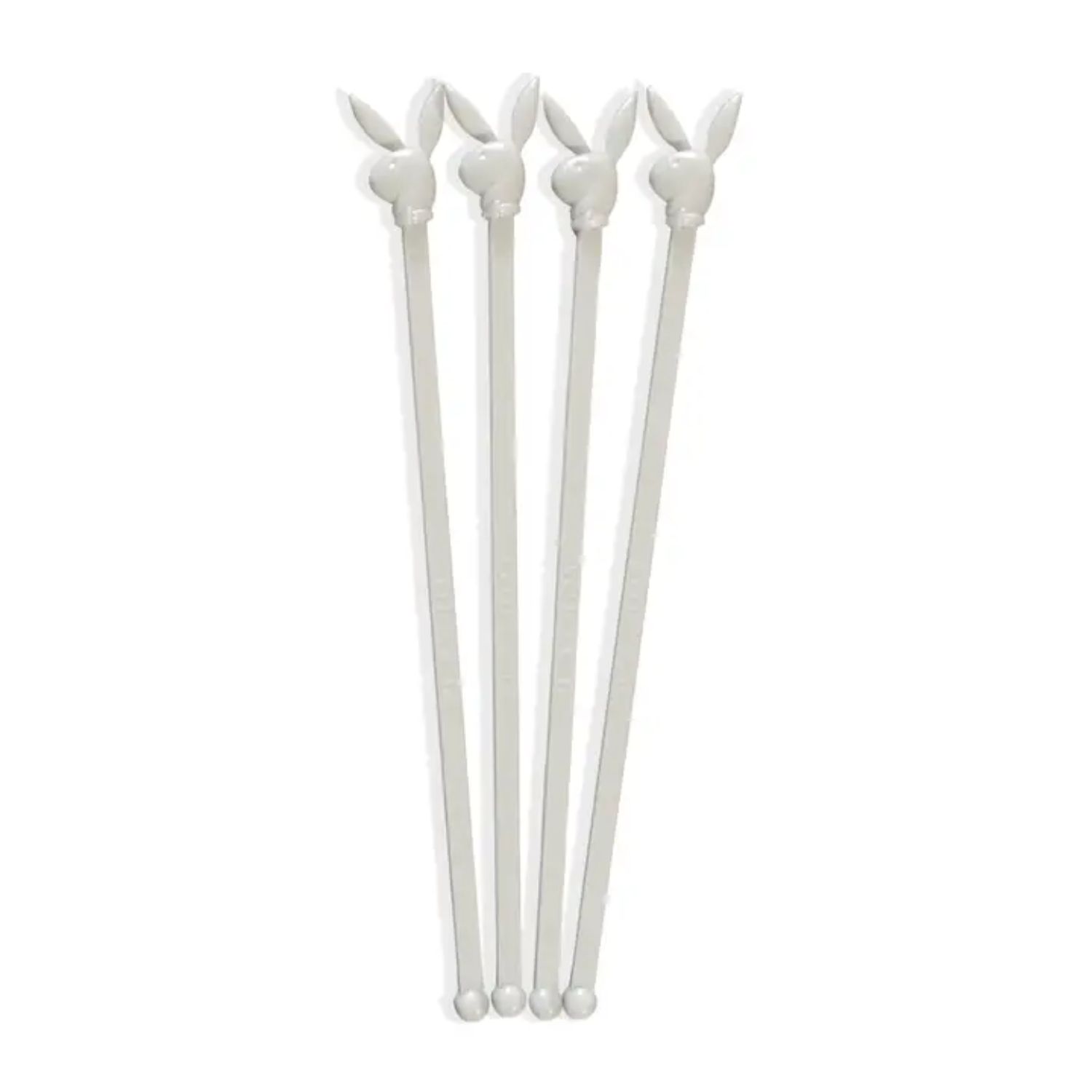 Set of four white Playboy Bunny-shaped stir sticks on a white background