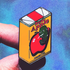 Enamel pin of a Quentin Tarantino Red Apple cigarette pack against a blue and purple gradient background