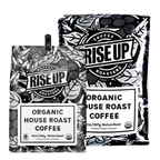 Two packages of Rise Up Coffee Roasters organic house roast coffee on a white background