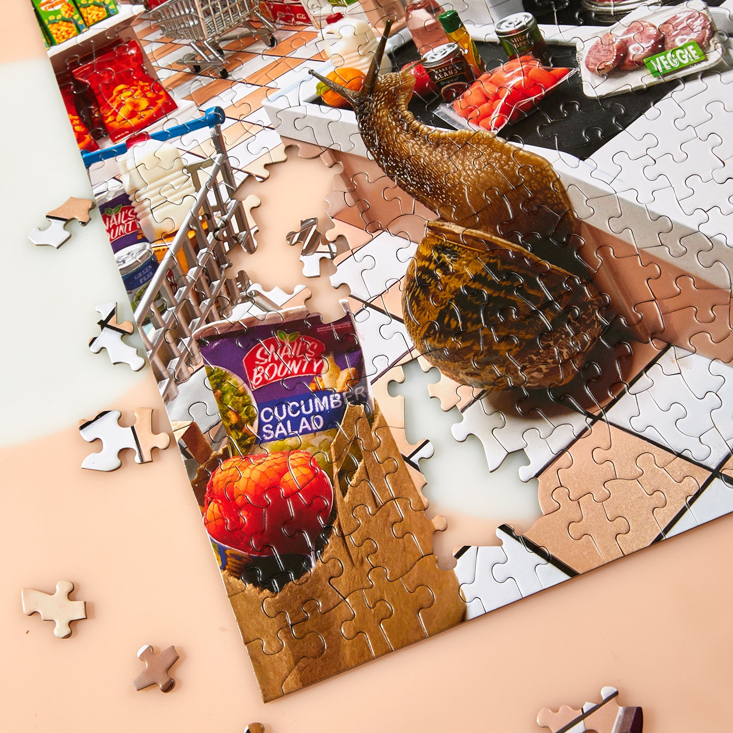 Jigsaw puzzle with a snail and salad package on a table