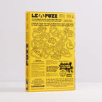 A yellow rectangular product box for 'LE PUZZ' shown upright against a light gray background. The front features a winding black line maze illustration with text instructions and promotional copy, including 'It's a real goo time!' and 'Snail Trails.