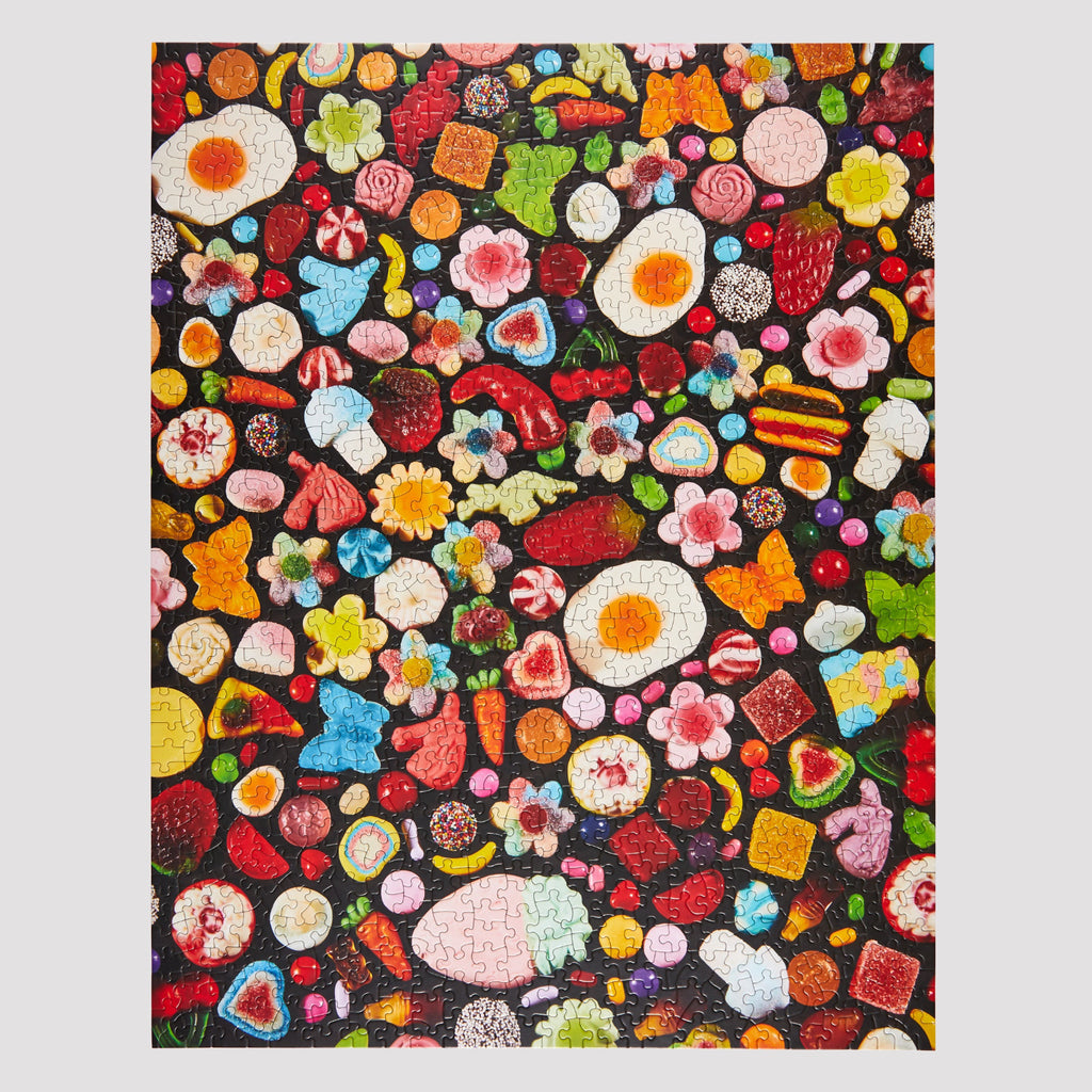 Colorful pattern of various gummy candies on a black background