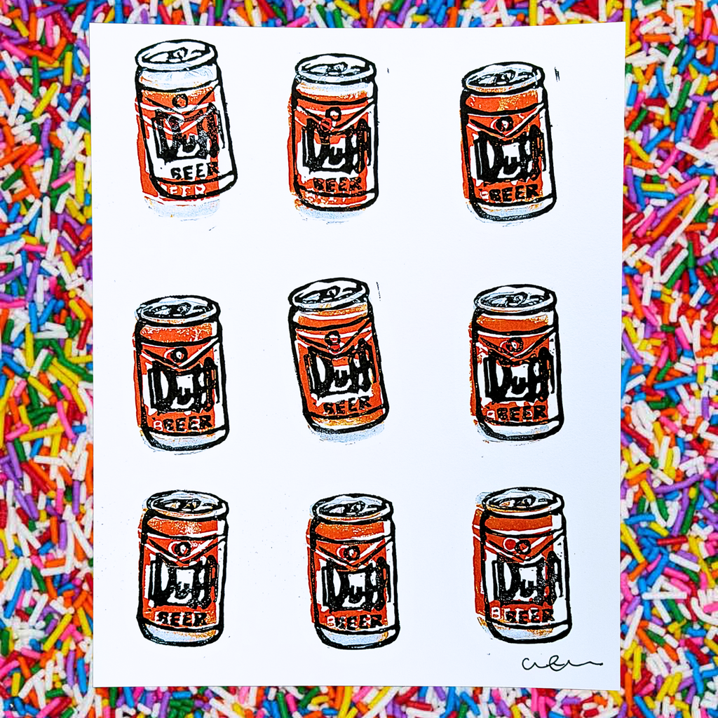 Multiple cans of Duff Beer printed on a white background with colorful sprinkles border.