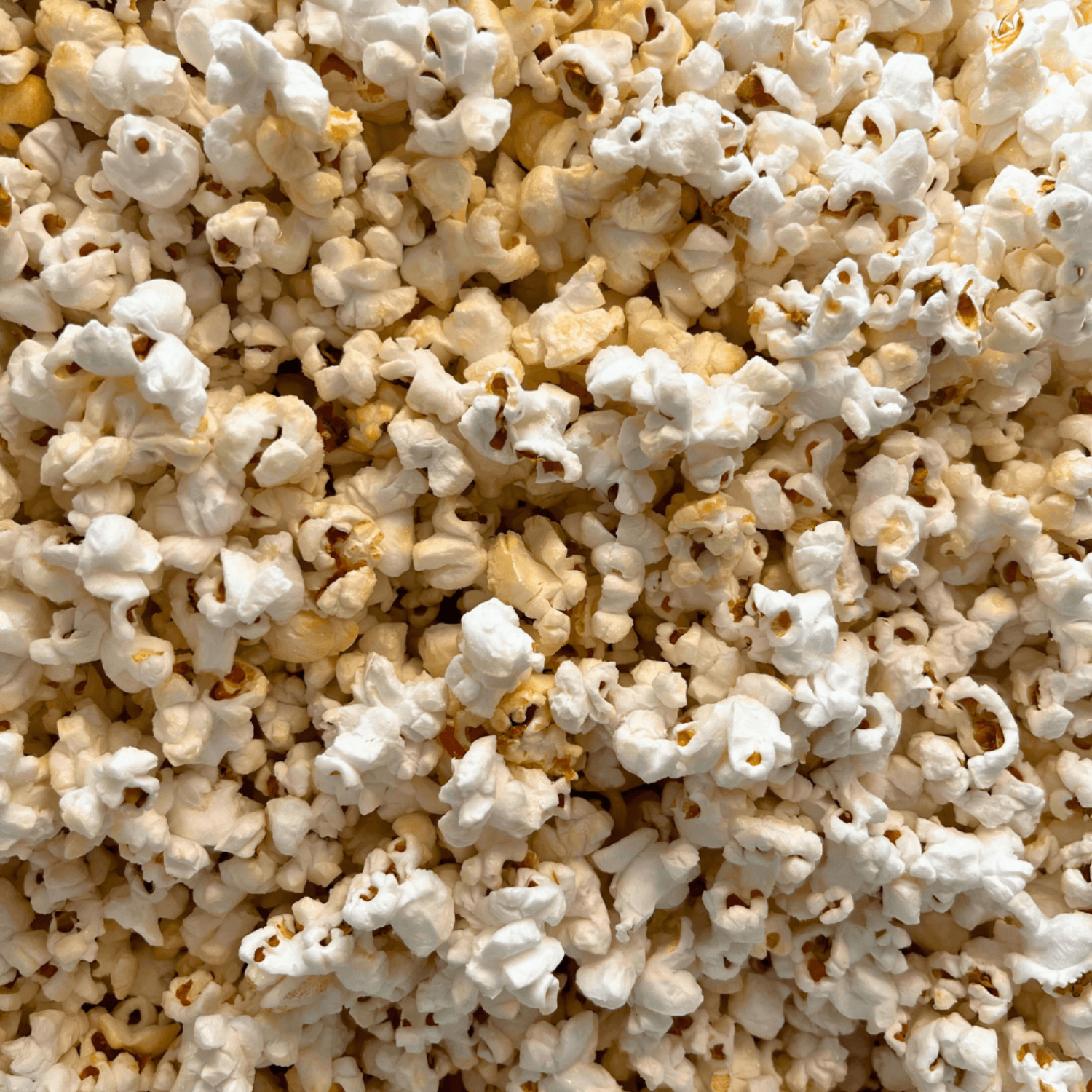 Close-up of white cheddar popcorn with a focus on texture and color.