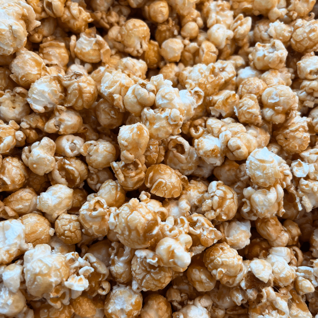 Close-up of caramel popcorn with a brown and white color palette.